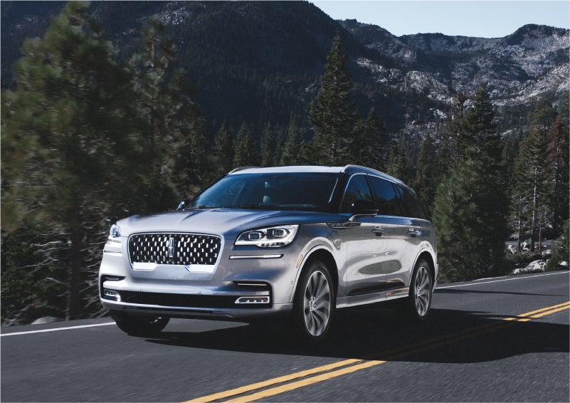 A 2023 Lincoln Aviator® Grand Touring SUV being driven on a winding road to demonstrate the capabilities of all-wheel drive | Sedano Lincoln in La Mesa CA
