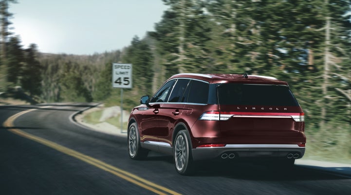 A 2024 Lincoln Aviator® SUV is being driven on a winding mountain road | Sedano Lincoln in La Mesa CA