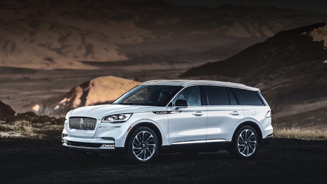 A 2024 Lincoln Aviator® SUV is parked at a mountain overlook | Sedano Lincoln in La Mesa CA