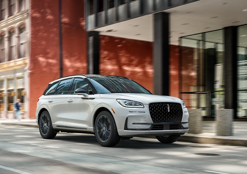 The 2024 Lincoln Corsair® SUV with the Jet Appearance Package and a Pristine White exterior is parked on a city street. | Sedano Lincoln in La Mesa CA