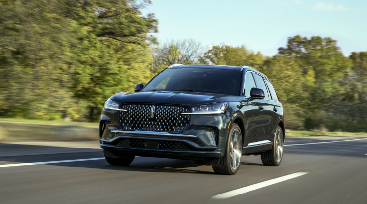 A 2025 Lincoln Black Label Aviator® SUV is being driven down a road lined with trees. | Sedano Lincoln in La Mesa CA