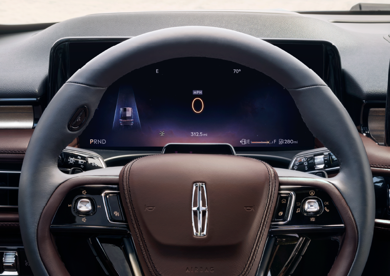The steering wheel of 2025 Lincoln Aviator® SUV is shown with black and brown accents. | Sedano Lincoln in La Mesa CA