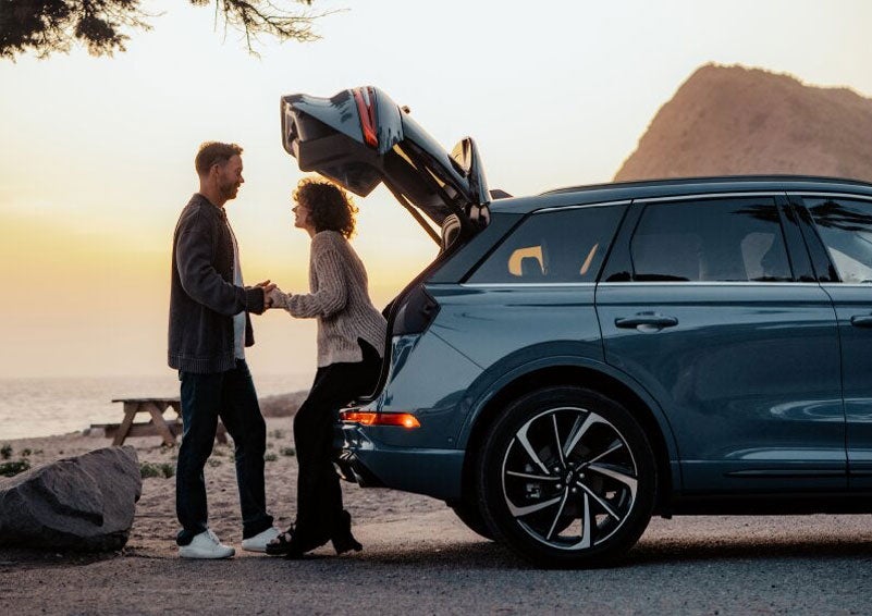 A couple share a moment together outside a 2025 Lincoln Corsair® SUV near the open liftgate. | Sedano Lincoln in La Mesa CA