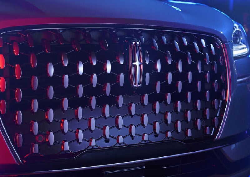The grille of a 2025 Lincoln Corsair® SUV reflects neon light at night. | Sedano Lincoln in La Mesa CA
