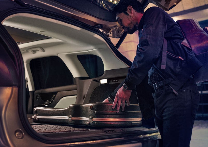 A man is shown loading cargo into the rear of a 2024 Lincoln Corsair® SUV with the second-row seats folded flat. | Sedano Lincoln in La Mesa CA