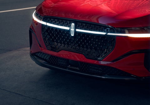 The available front LED light bar and center Lincoln Star logo glow at dusk. | Sedano Lincoln in La Mesa CA