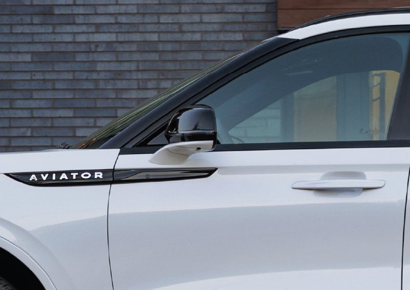 The driver’s side door and fender badging of a white 2026 Lincoln Aviator® SUV are showcased. | Sedano Lincoln in La Mesa CA