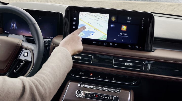 A person is tapping the center display touchscreen of a 2026 Lincoln Aviator® SUV. | Sedano Lincoln in La Mesa CA