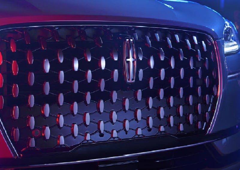 The grille of a 2025 Lincoln Corsair&reg; SUV reflects neon light at night. | Sedano Lincoln in La Mesa CA