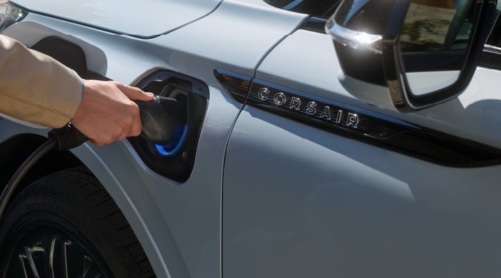 A hand is plugging in a 2026 Lincoln Corsair® Grand Touring Plug-in Hybrid SUV. | Sedano Lincoln in La Mesa CA