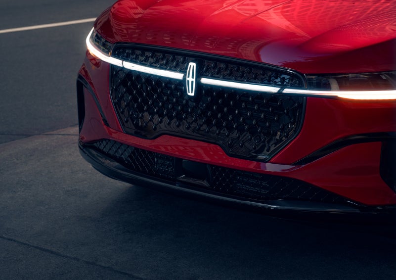 The available front LED light bar and center Lincoln Star logo glow at dusk. | Sedano Lincoln in La Mesa CA