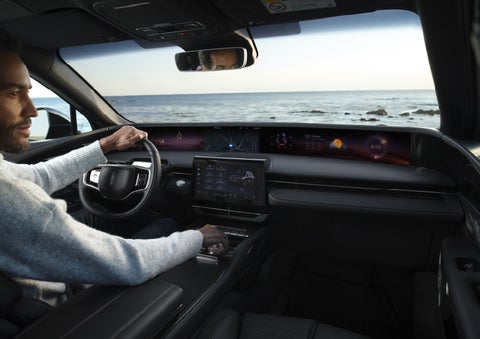 A driver of a parked 2026 Lincoln Nautilus® SUV takes a relaxing moment at a seaside overlook while inside his Nautilus. | Sedano Lincoln in La Mesa CA