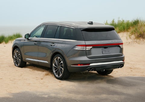 A 2027 Lincoln Aviator® SUV is parked next to sand dunes. | Sedano Lincoln in La Mesa CA