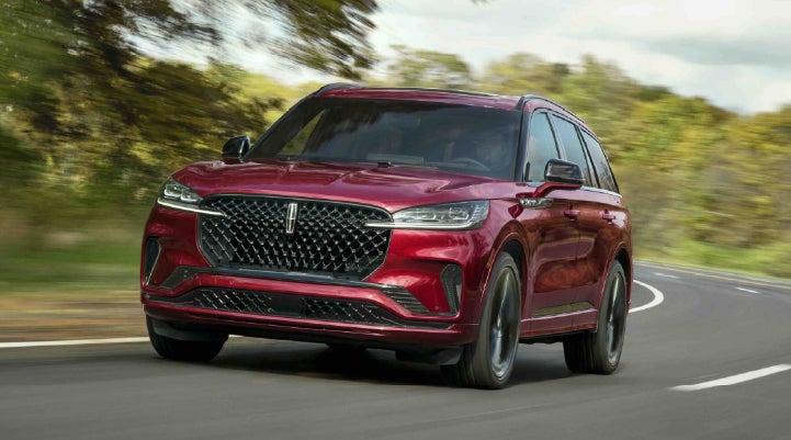 A 2027 Lincoln Aviator® SUV is being driven on a country road | Sedano Lincoln in La Mesa CA