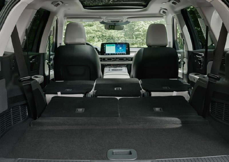 A rear to front view of the interior of a 2027 Lincoln Aviator® Black Label™ SUV shows the third and second rows folded flat | Sedano Lincoln in La Mesa CA