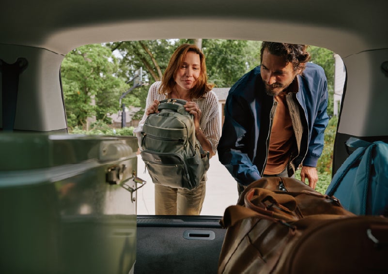 A couple loads luggage into the rear of a 2027 Lincoln Aviator® Black Label™ SUV..e 202 | Sedano Lincoln in La Mesa CA